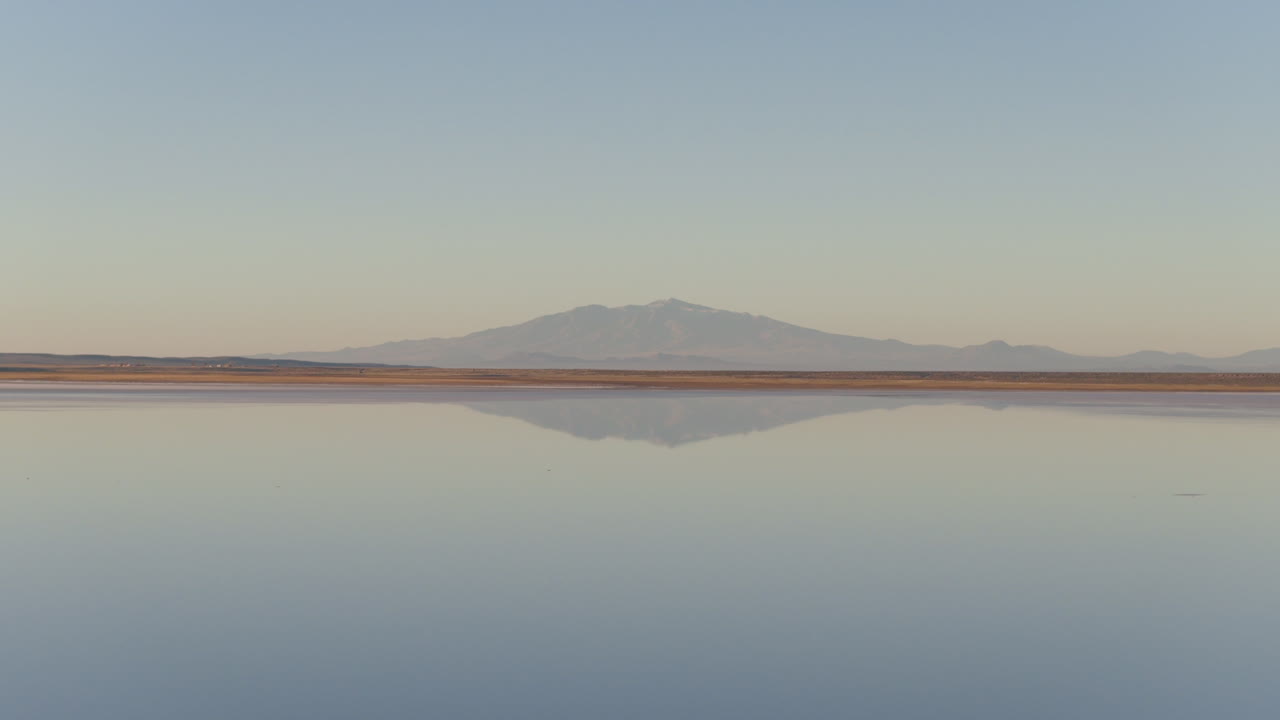 Andean mountain landscape mirrored in Salinas del Diamante salt flats, Mendoza, Aerial view, Argentina