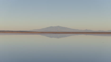 andean mountain landscape mirrored in salinas del diamante salt flats, mendoza, aerial view, argentina