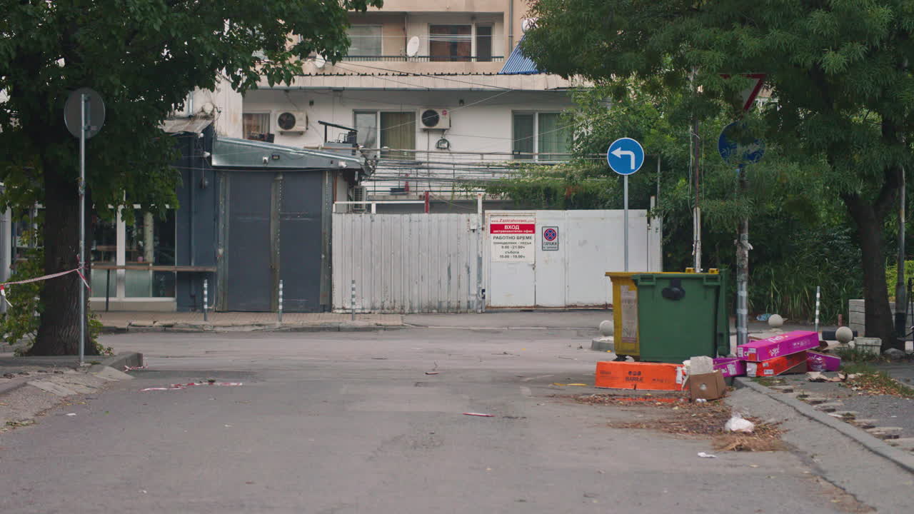 Abandoned construction materials, furniture, boxes and clothes near a dumpster in Sofia, Bulgaria