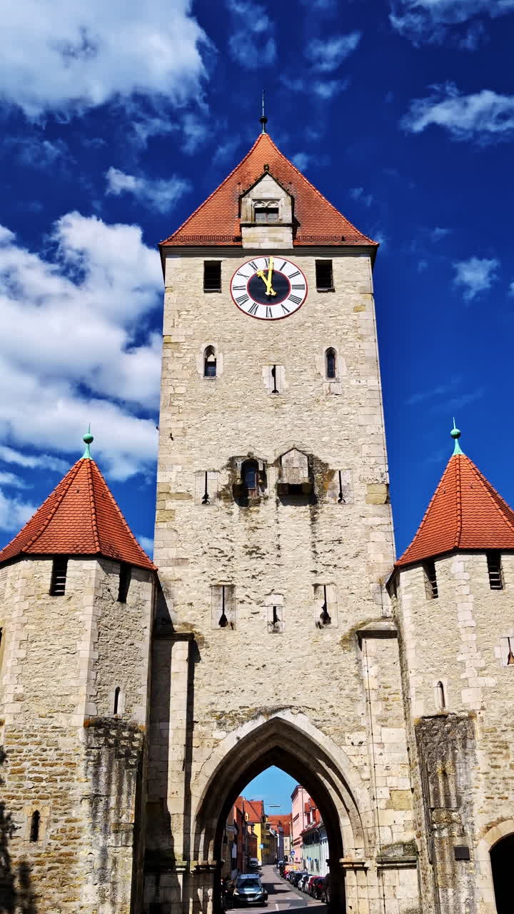 Detailed Front View of Ostentor Clock Gate Tower Under Bright Blue Sky. Vertical shot