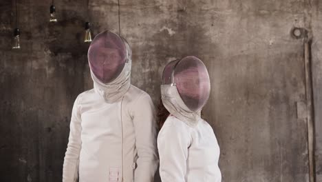 two fencers in a studio