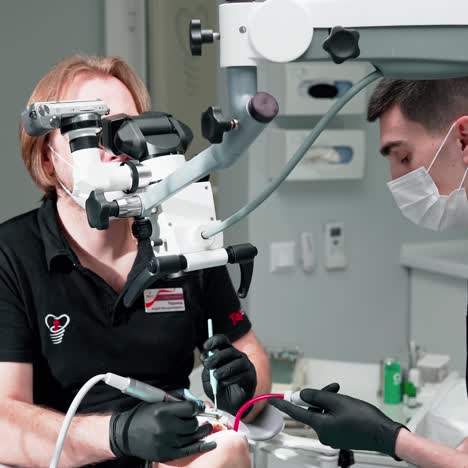 doctor using microscope at dental clinic