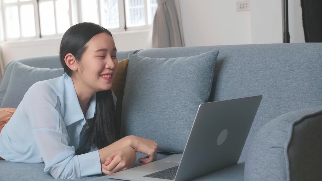Woman Lying On A Sofa And Video Call With Someone In Home Living Room, Video In 4K