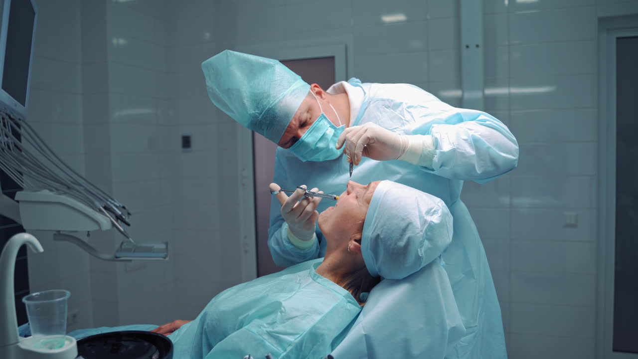 Dentist operating oral cavity of patient. Dental hygienist in operation with patient