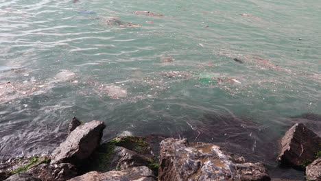 Soiled-waves-by-the-rocky-shoreline-of-Istanbul--close-up