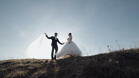 newlyweds. caucasian groom with bride on mountain slope. wedding couple. happy