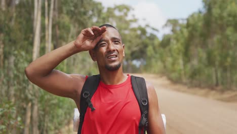 sporty mixed race man with prosthetic leg hiking