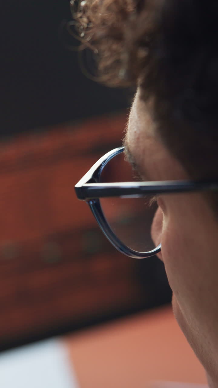 Close-up Side Profile of a Man Wearing Glasses Looking Intently