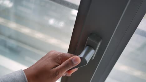 person opening a sliding window