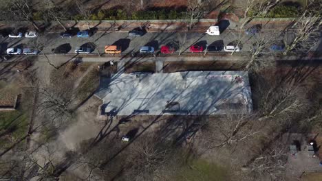 aerial view of a berlin skate park during mild winter, showing skaters, urban landscape, and cold-season city vibes