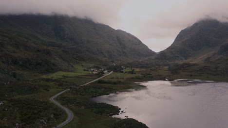 misty valley with lake and road