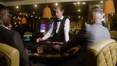 Multiethnic-group-of-people-joining-the-poker-table-in-the-casino.