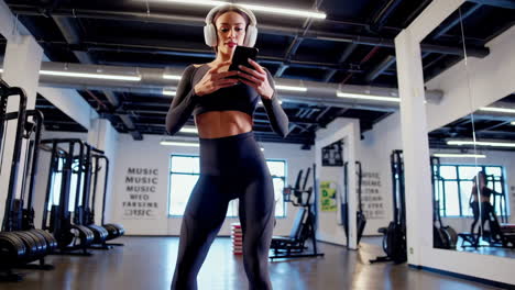 woman using smartphone in gym