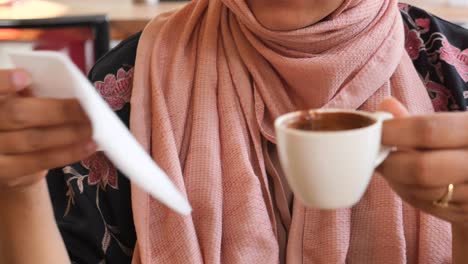 woman drinking turkish coffee in a cafe