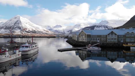 Droneview-of-a-small-fishing-village-with-mountains-in-the-background