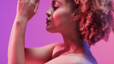 biracial woman with dark hair in blue and pink light, slow motion