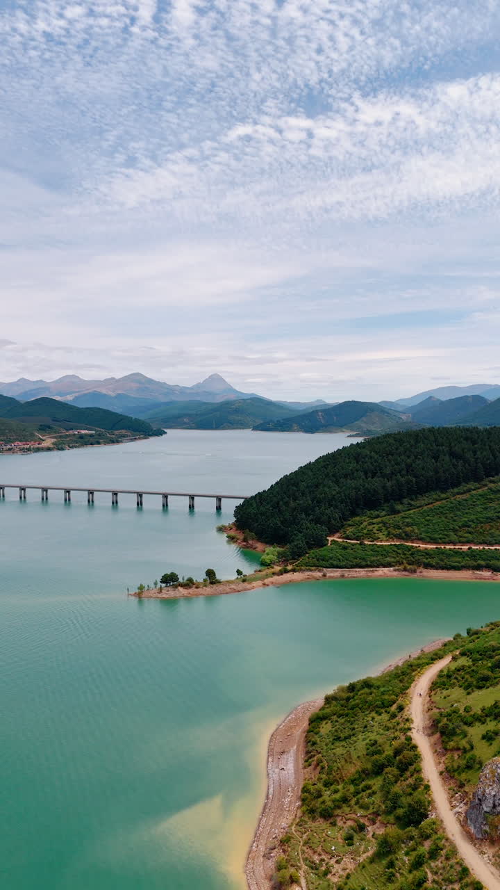 Amazing nature of the national park in Leon, Spain, Europe. Drone flight over the blue lake surrounded by the mountain range. Vertical video.
