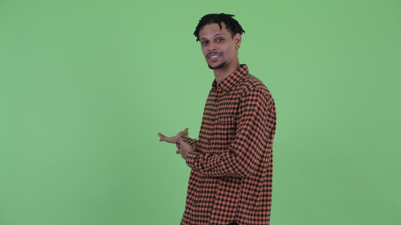 Happy young handsome African man with dreadlocks