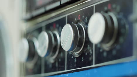 adjusting the temperature on a vintage stovetop