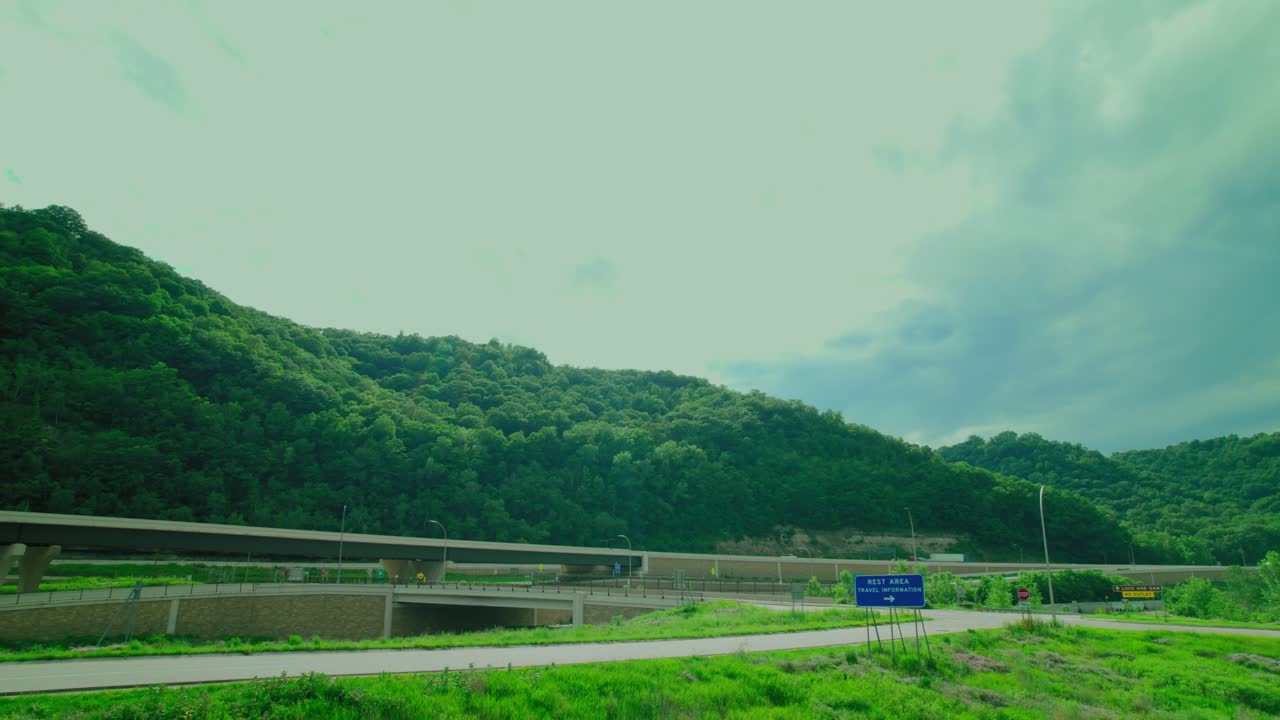 Scenic Highway View with Mountains and Rest Area