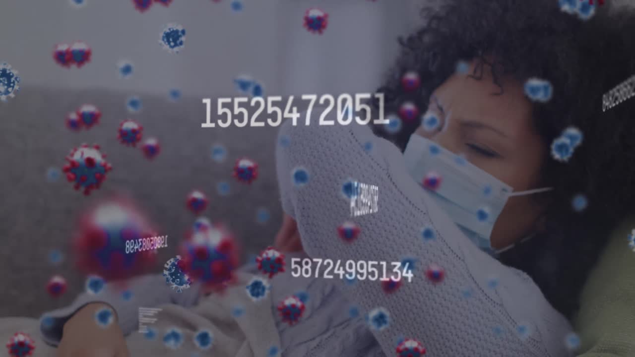 Video of falling covid 19 cells over biracial woman wearing face mask