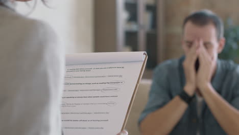 psychotherapist conducting session with emotional man
