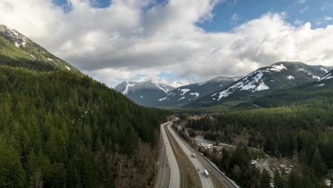 traffic flows under boiling skies high up in the mountains of washington, usa, aerial hyper lapse