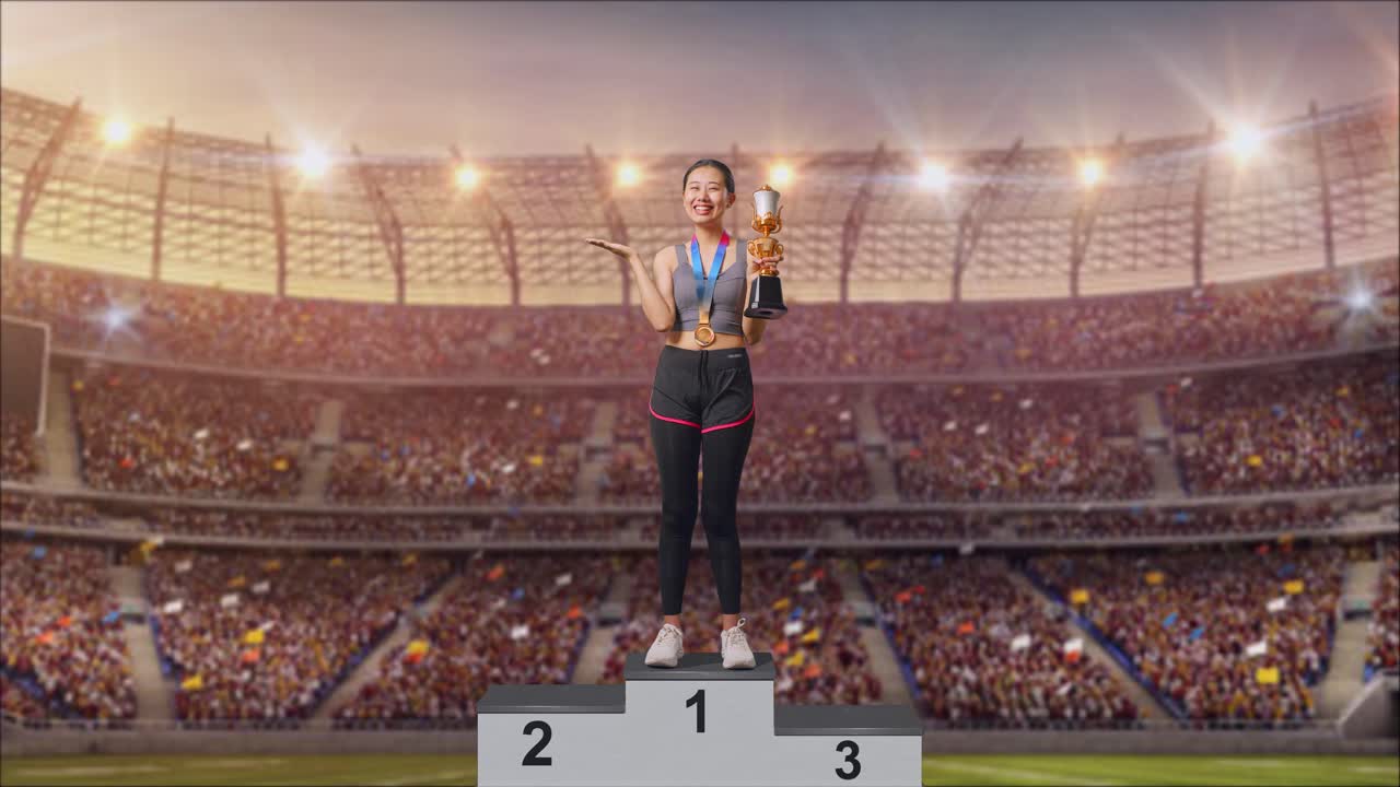Full Body Of Asian Woman With A Gold Medal Looking At A Gold Trophy In Her Hands, Smiling, And Pointing To Side At The Stadium