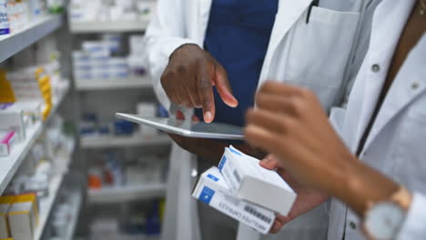 4k footage of two pharmacist using a digital