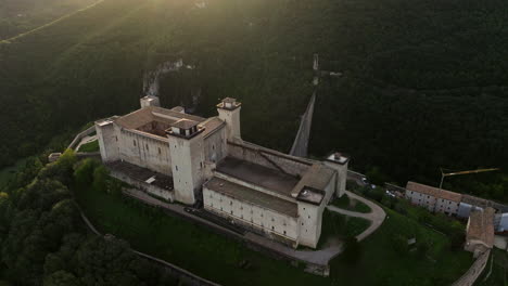 vista aérea del castillo de rocca albornoziana en spoleto, italia al amanecer - disparo de drone