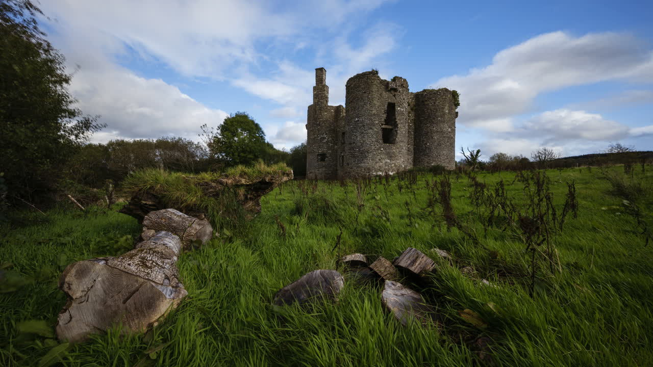lapso de tiempo de la ruina de un castillo medieval en el campo rural de irlanda durante un día soleado y nublado
