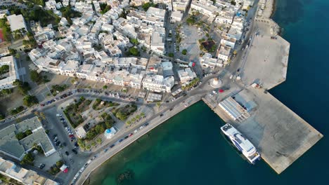 Aerial-footage-of-the-town-and-port-of-Parikia-on-the-island-of-Paros,-one-of-the-many-Cyclades-Islands-in-the-Aegean-Sea