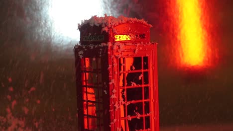 snowing on an english phone booth