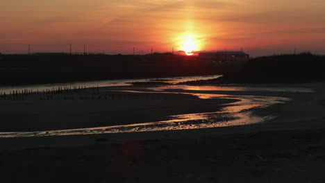 glorious sunset scenery by the vieira beach harbor in portugal - right panning shot