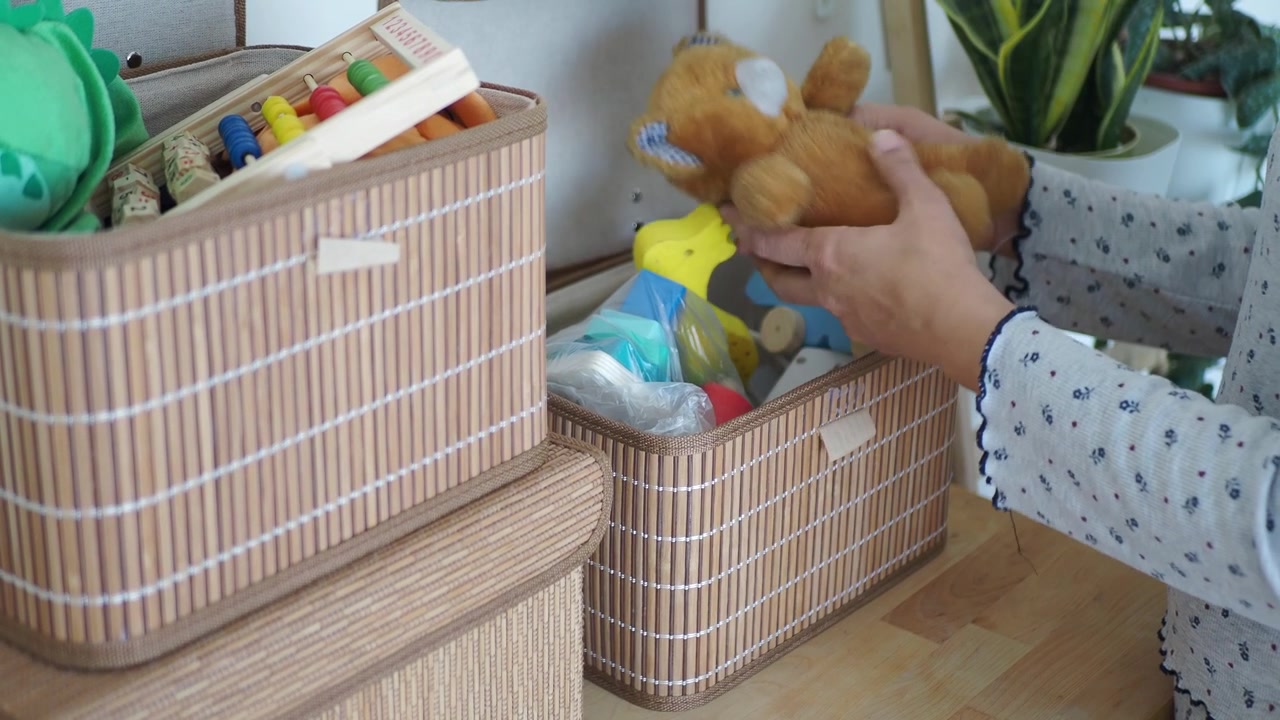Woman Organizing Toys in Bamboo Storage Baskets