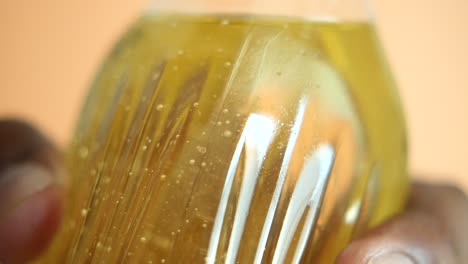 close-up of a plastic bottle of a yellow liquid