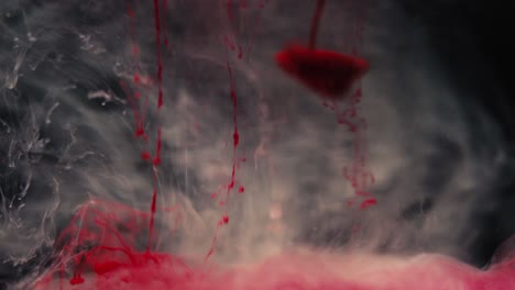 red paint dissolving in water shot in slow motion with sony a7iii.