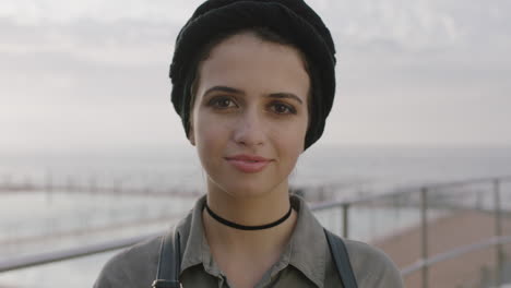 close up portrait of friendly young woman looking confident by seaside