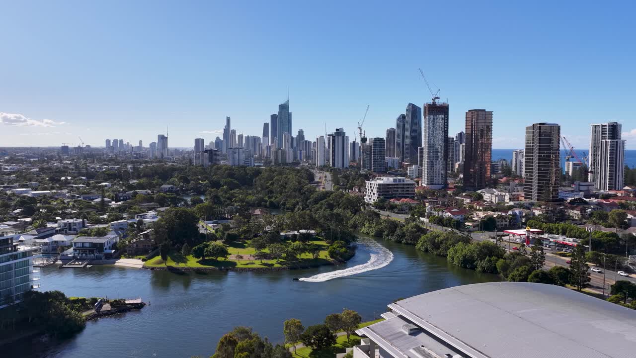 Drone footage captures the vibrant skyline and waterways of Gold Coast, Australia, under clear blue skies