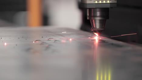 factory automated laser cutter working and cutting stainless metal sheet