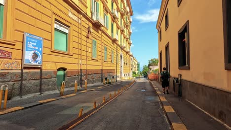 people walking along colorful naples street