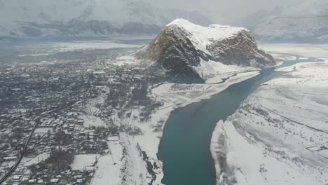 aerial view of snow covered village town in skardu city, gilgit-baltistan beside indus river