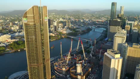 aerial view of tower cranes on the top of queen's wharf next to 1 william street building in brisbane city, queensland, australia