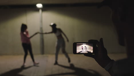 dancing woman happy hip hop dancer girls dance under street light friend using smartphone taking video enjoying sharing on social media in city at night