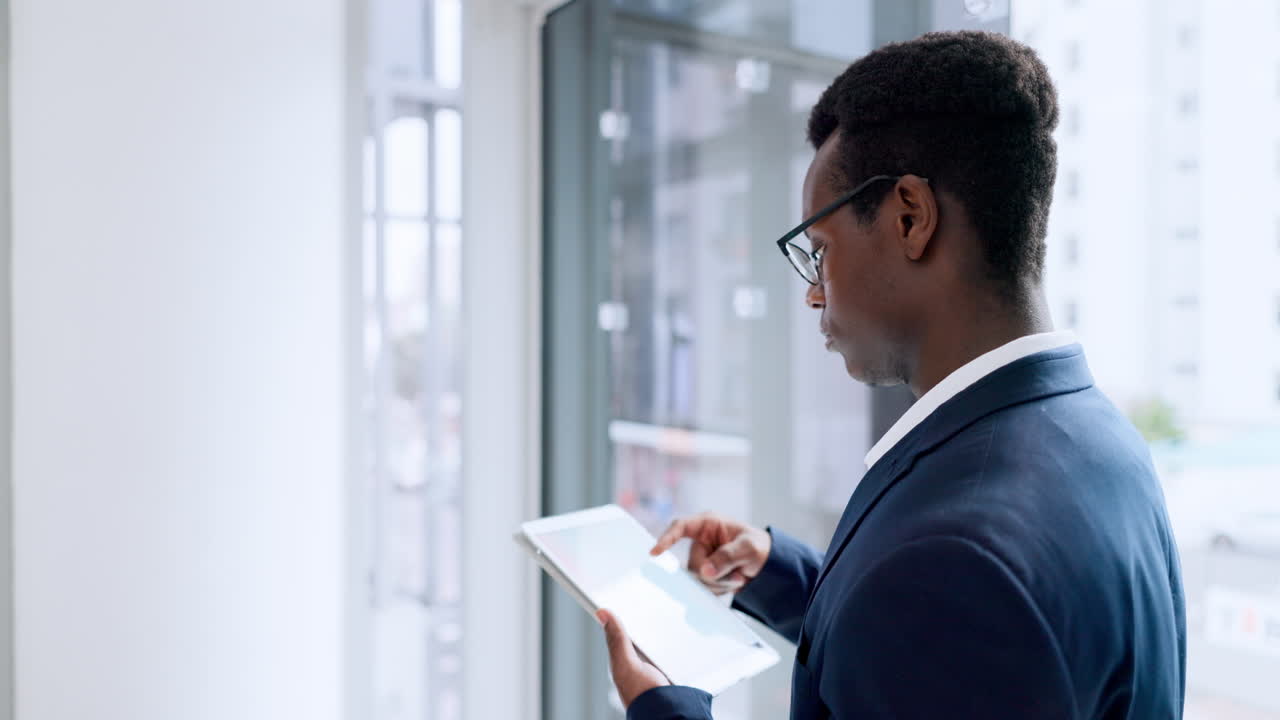 Businessman, tablet and research by window