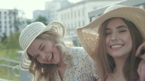 two women wearing straw hats