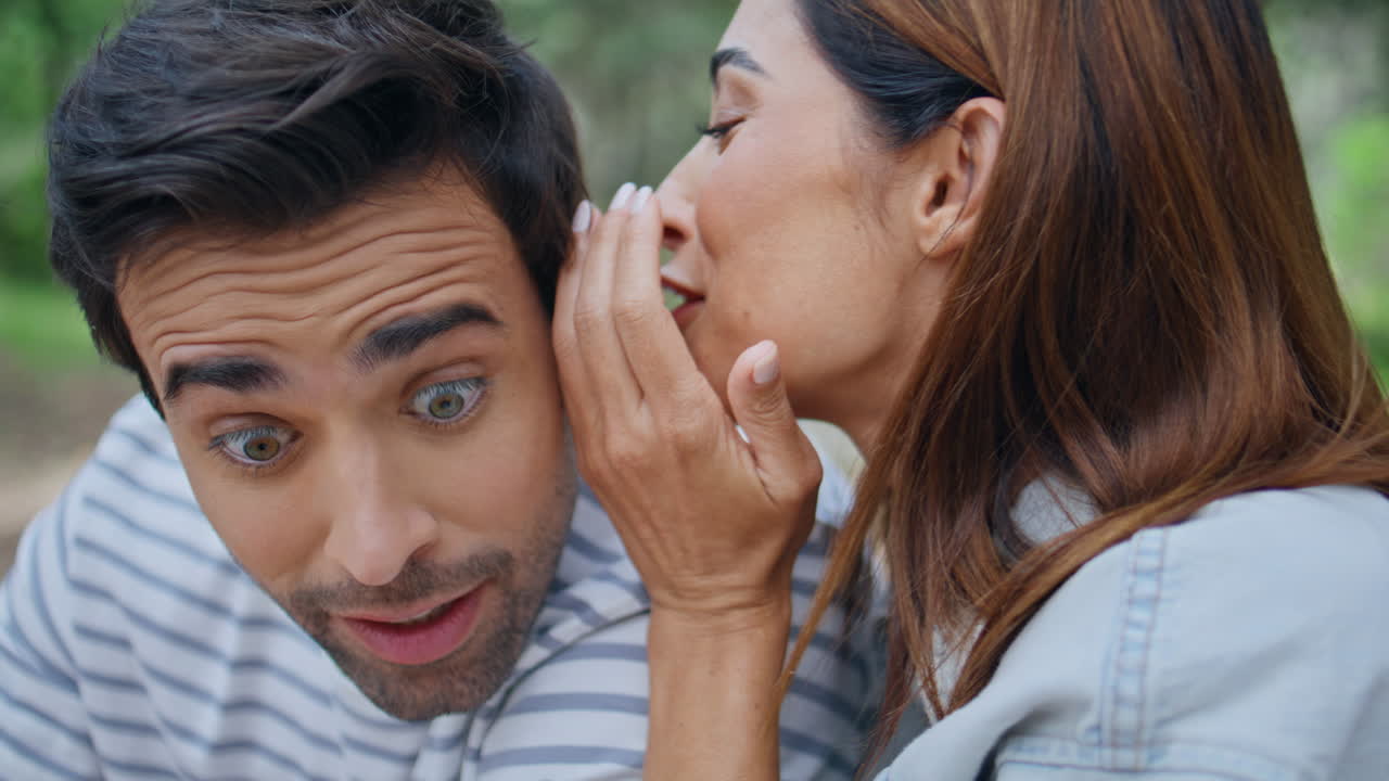 Happy couple gossiping nature spending weekend together closeup. Girl whispering