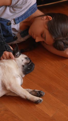 girl and pug sleeping on the floor