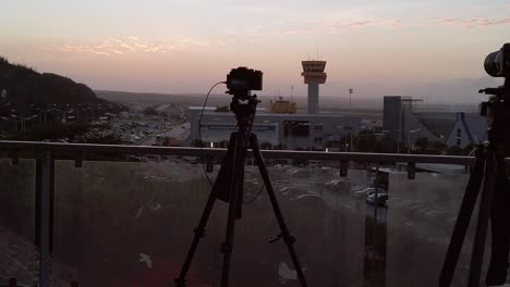 panning from left to right capturing two cameras capturing curacao international airport when dusk is near