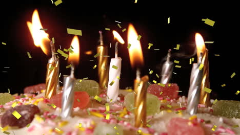 animación de confeti de oro cayendo sobre velas encendidas en el pastel de cumpleaños, apagado